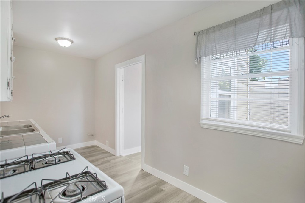 315 West Elm Street Brea, CA 92821 - Photo 8 of 14 a view of a bedroom with wooden floor and a window
