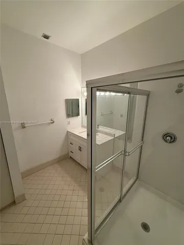 a bathroom with a mirror and a shower