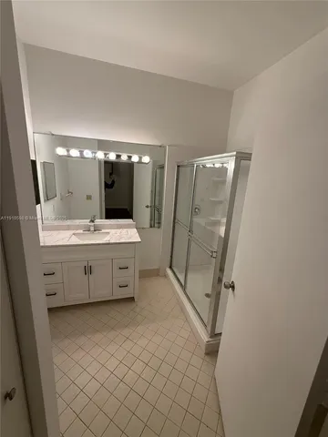 an empty room with wooden floor fan and window