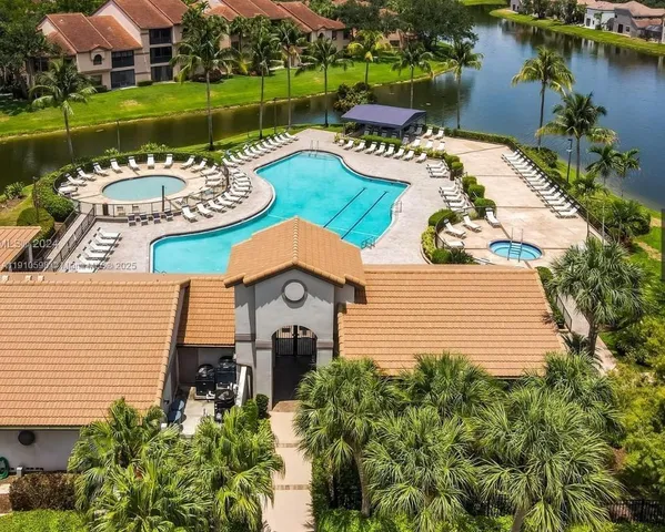 a view of a house with garden space and a patio