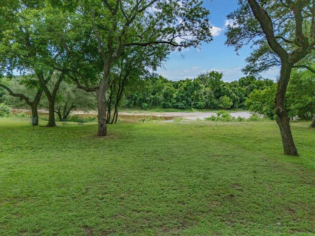 10106 Ravenswood Road Granbury, TX 76049 - Photo 29 of 39 a view of field with trees in the background