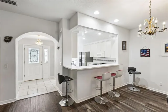 a kitchen with kitchen island a counter top space a sink stainless steel appliances and cabinets