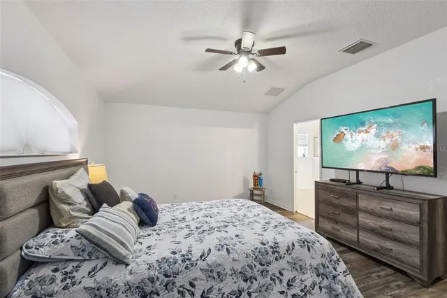 a bedroom with furniture and a flat screen tv
