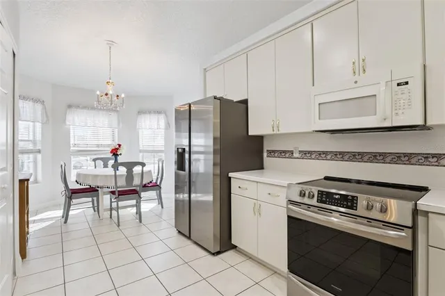 a kitchen with stainless steel appliances granite countertop a stove a refrigerator and a refrigerator