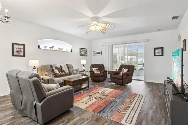 a living room with furniture a table and a chandelier