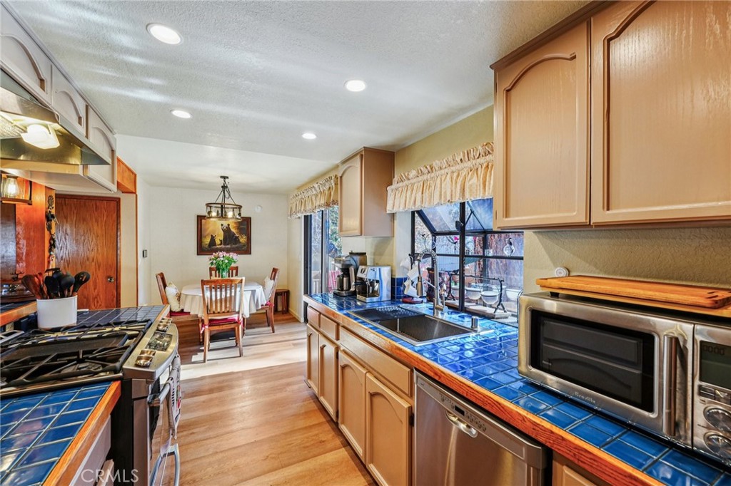 1847 Thrush Road Wrightwood, CA 92397 - Photo 7 of 33 a kitchen with stainless steel appliances a stove and cabinets