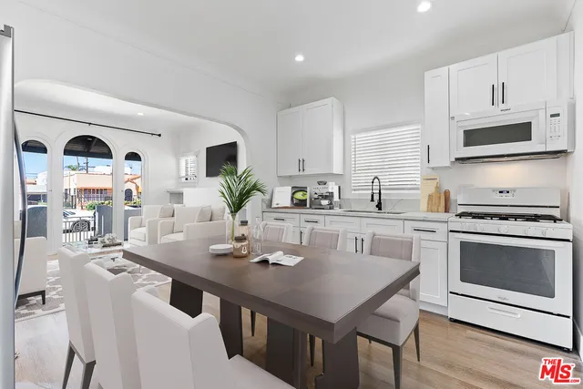 a kitchen with a stove a sink and a refrigerator