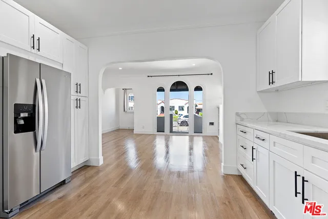 a view of a kitchen cabinets and wooden floor