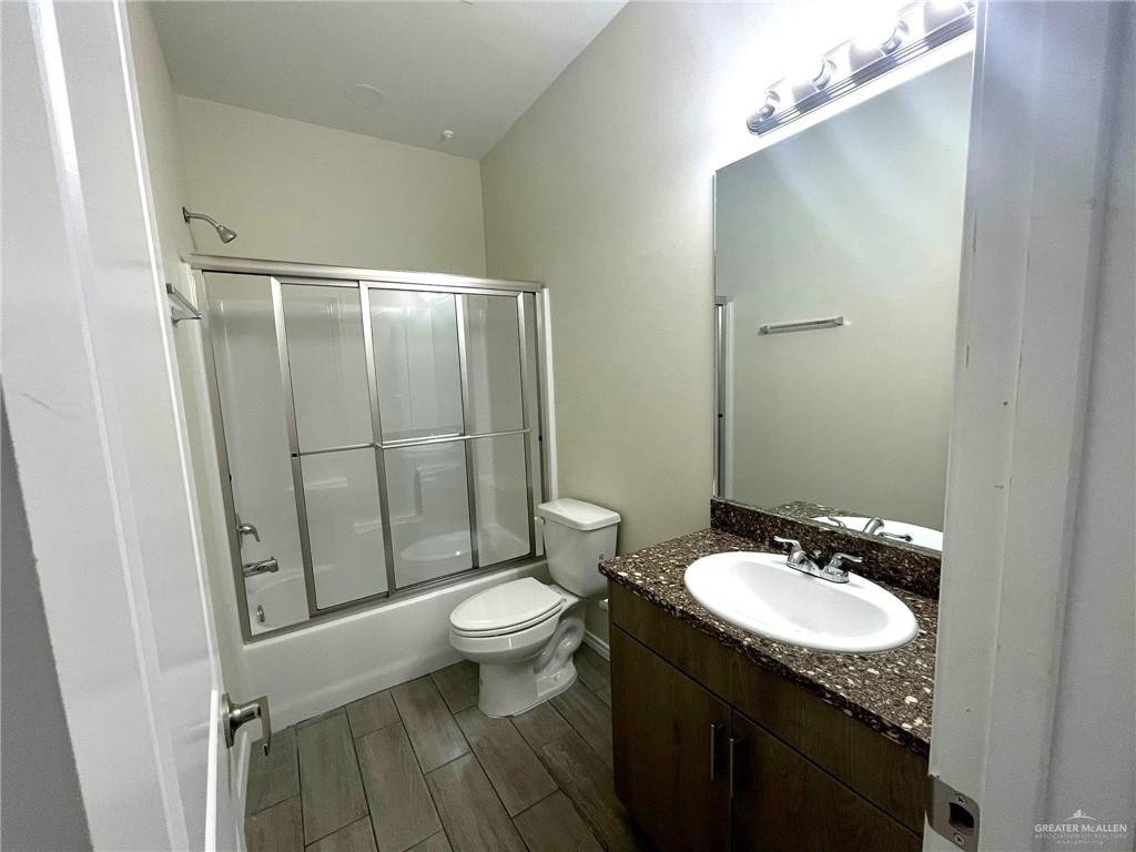 5007 North Hiawatha Drive, Unit 4 Pharr, TX 78577 - Photo 11 of 14 a bathroom with a granite countertop sink toilet and shower