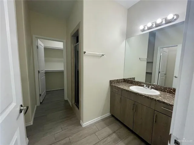a bathroom with a double vanity sink and mirror
