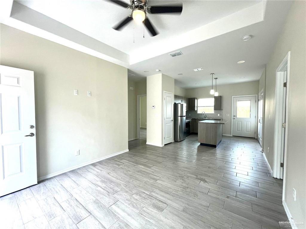 5007 North Hiawatha Drive, Unit 4 Pharr, TX 78577 - Photo 3 of 14 a view of a kitchen with a sink and a refrigerator