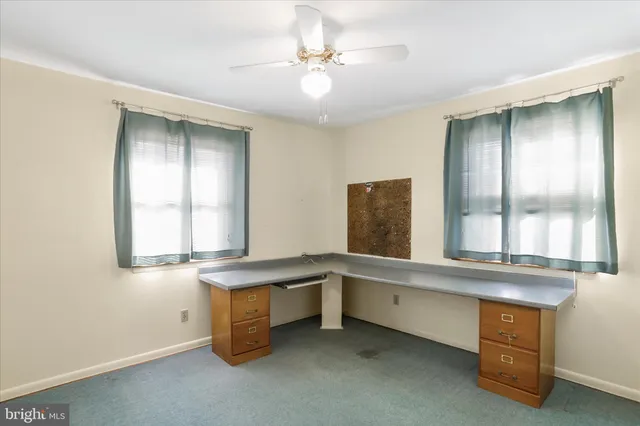 a room with a window and a dresser