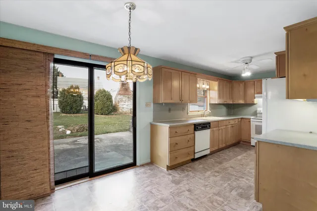 a open kitchen with window refrigerator and cabinets