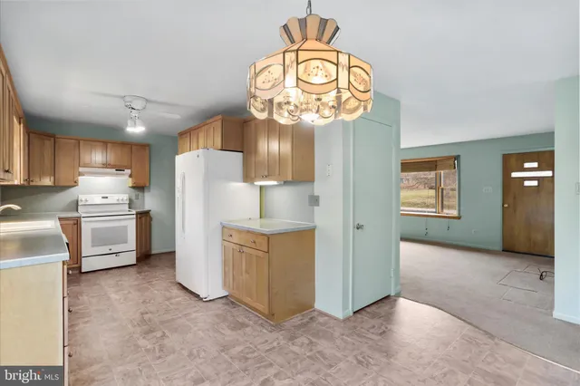 a view of kitchen and refrigerator