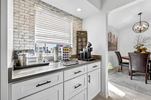 a kitchen with appliances cabinets and furniture