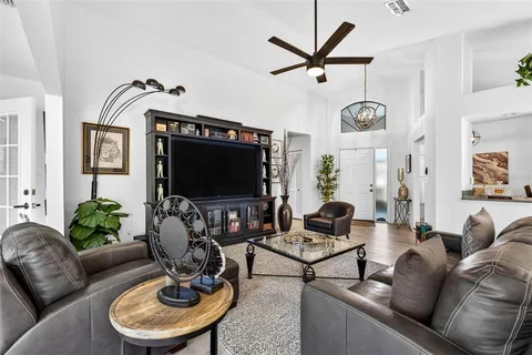 a living room with furniture a rug and a flat screen tv