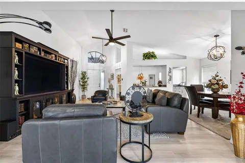 a living room with fireplace furniture and a flat screen tv