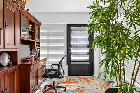a backyard of a house with barbeque oven table and chairs