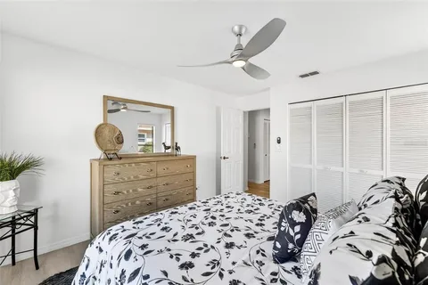 a bedroom with a bed and a dresser in it