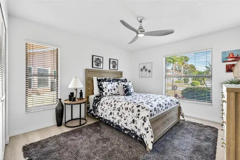 a bedroom with a bed chair and window
