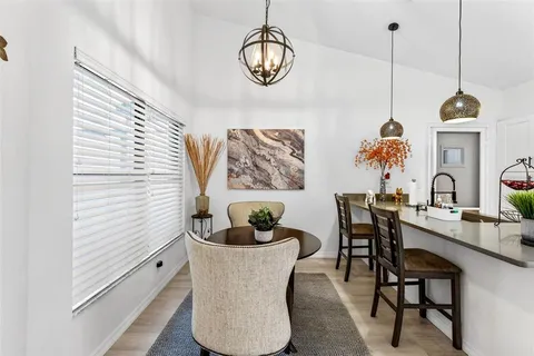 a dining room with furniture and window