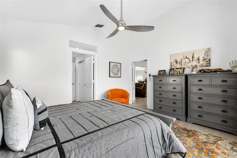 a bedroom with a bed dresser and a window