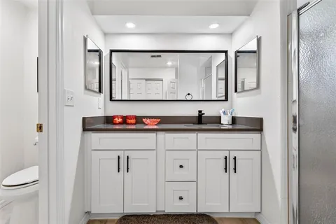a bathroom with a sink vanity and a mirror