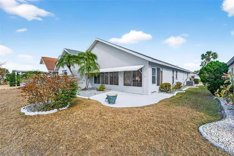 a front view of a house with a yard and potted plants