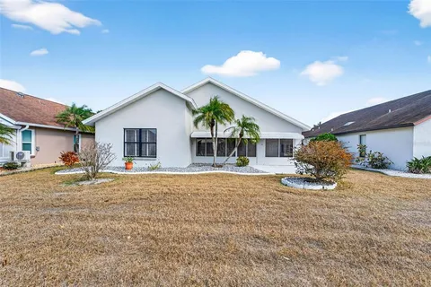 a view of a house with backyard and sitting area