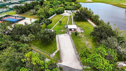 an aerial view of a house with swimming pool and garden
