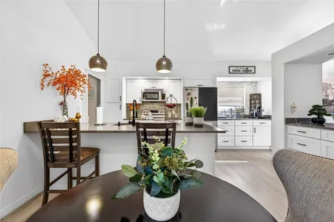 a living room with furniture a chandelier and a wooden floor