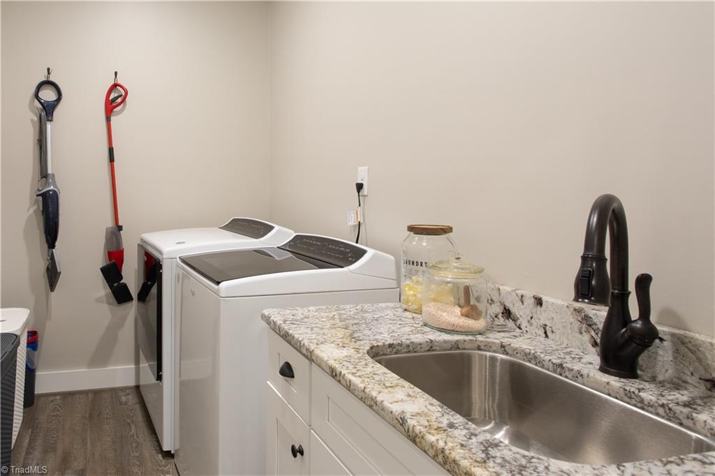 393 Scout Road Lexington, NC 27292 - Photo 23 of 47 The laundry room is the perfect size with its own sink and counter space. Located on the main level, close to the primary suite, this room is sure to be a busy place!