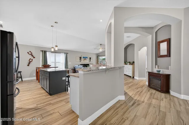 a view of kitchen with sink microwave and refrigerator