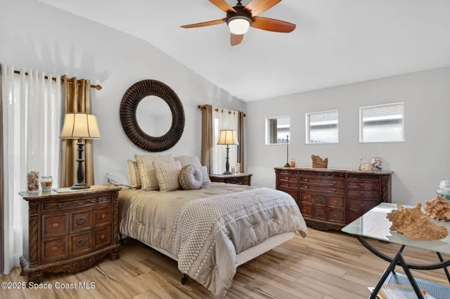 a bedroom with a bed and dresser with mirror