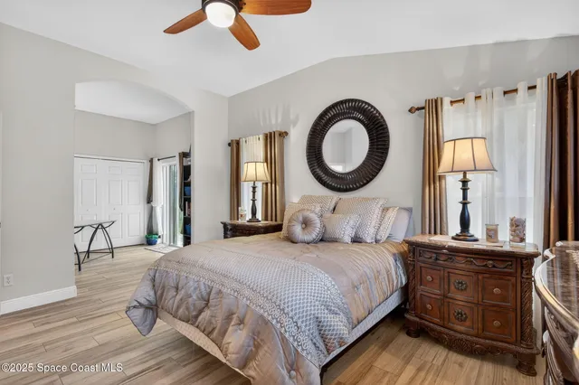 a bedroom with a large bed and a large window