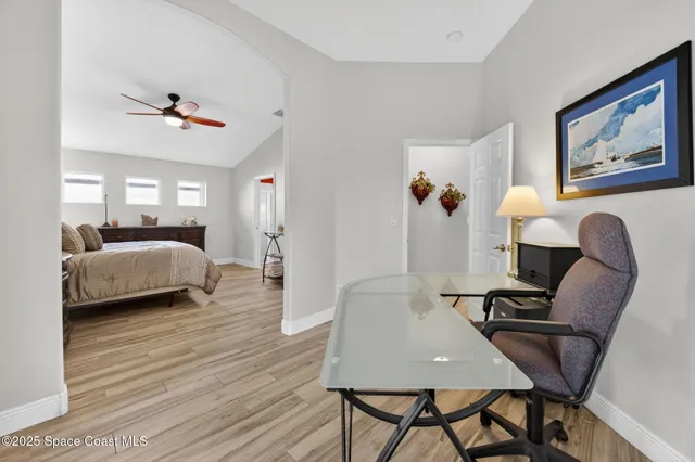a bedroom with furniture and wooden floor