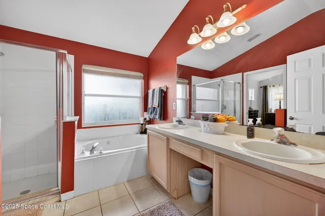 a bathroom with a double vanity sink a toilet and a mirror