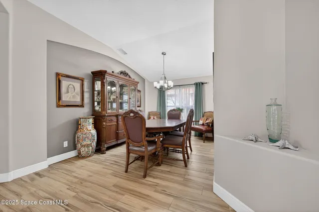 a view of a dining room with furniture and window