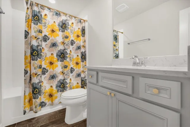 a bathroom with a sink toilet and shower