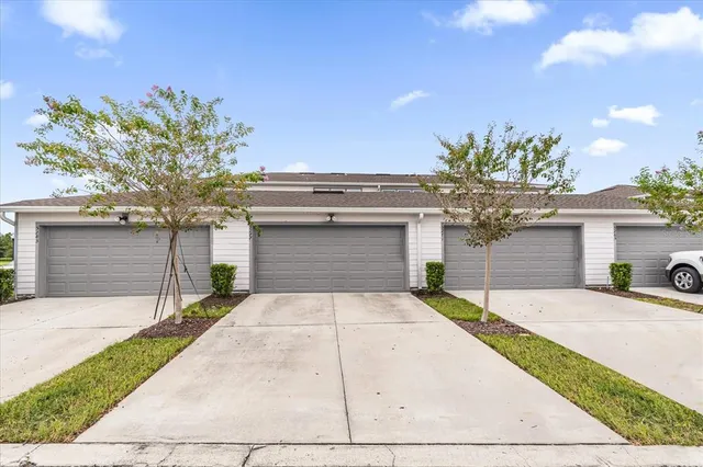 a front view of a house with a yard and a garage
