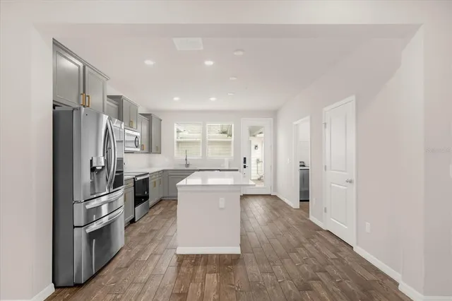 a kitchen with a refrigerator and a sink
