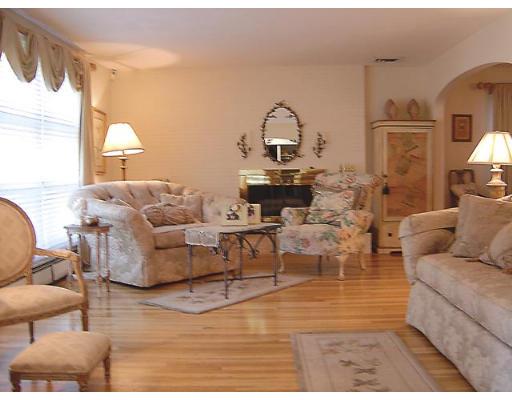 20 Wendell Road Newton, MA 02459 - Photo 2 of 11 a living room with couches a coffee table and painting on the wall