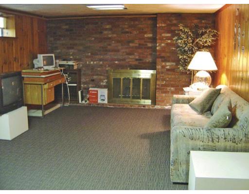 20 Wendell Road Newton, MA 02459 - Photo 4 of 11 a living room with furniture a flat screen tv and a floor to ceiling window