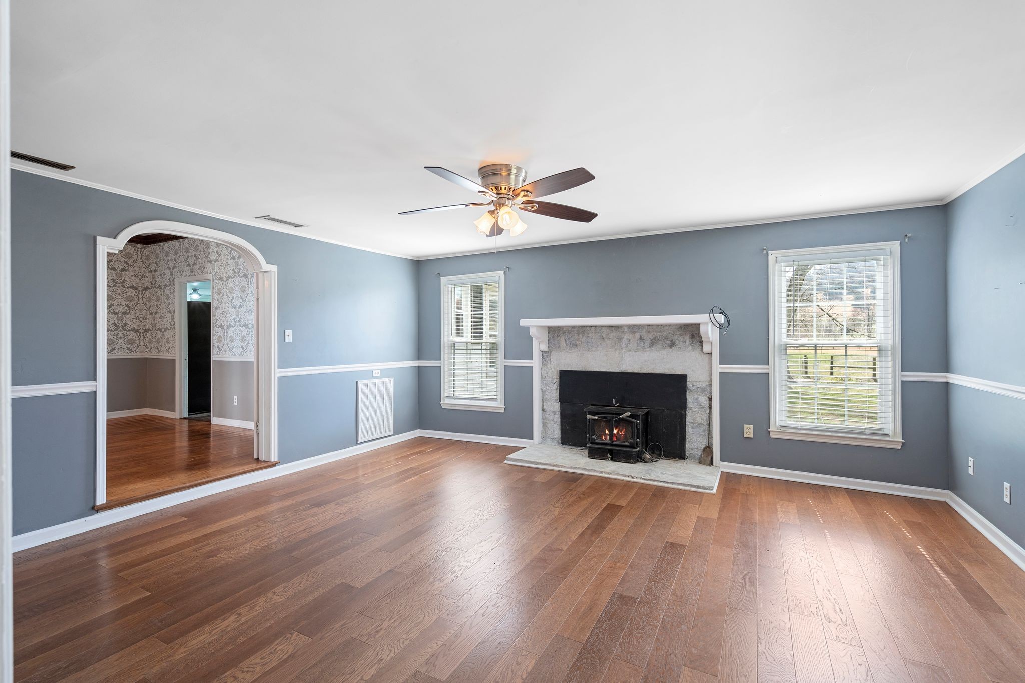 420 Beechwood Road Bell Buckle, TN 37020 - Photo 13 of 57 an empty room with windows a fireplace and wooden floor