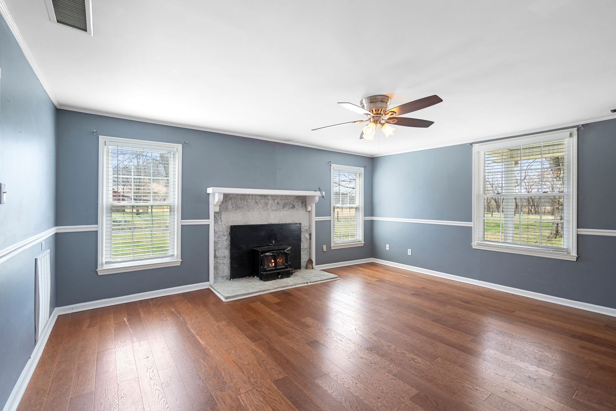 420 Beechwood Road Bell Buckle, TN 37020 - Photo 14 of 57 an empty room with windows and a fireplace
