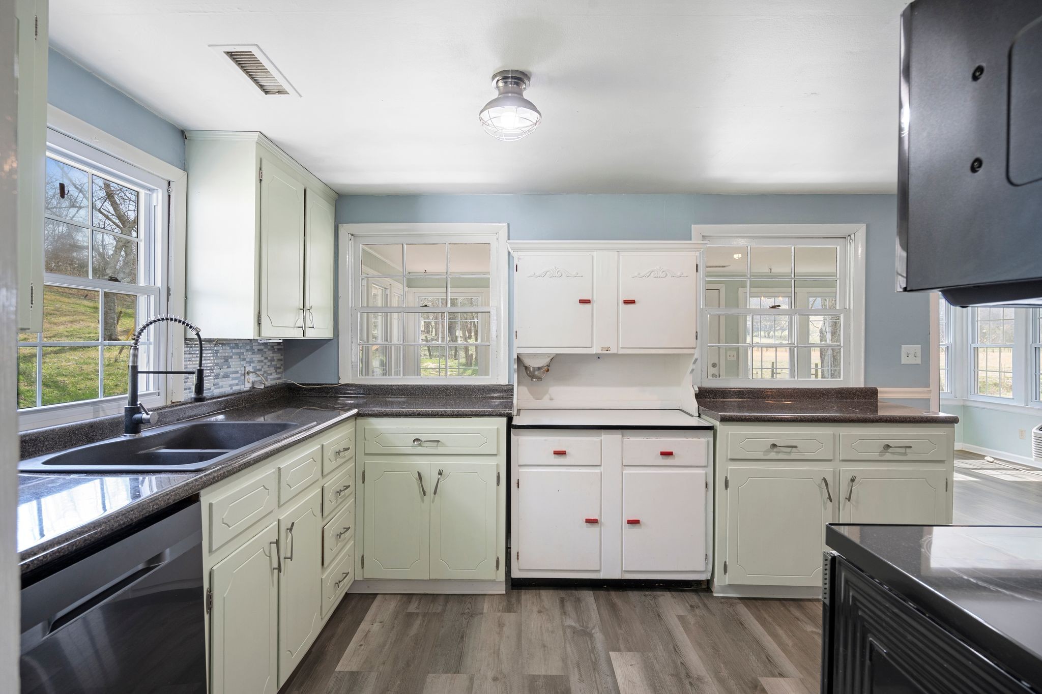 420 Beechwood Road Bell Buckle, TN 37020 - Photo 20 of 57 a kitchen with a sink stove cabinets and wooden floor