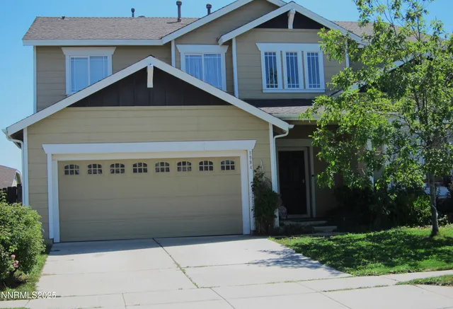 a front view of a house with garage