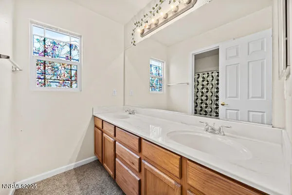 a bathroom with a double vanity sink and a mirror