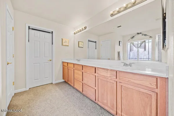 a spacious bathroom with a granite countertop sink a mirror and a shower