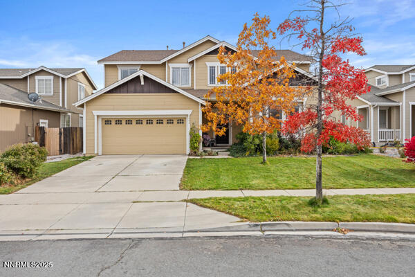 8994 Wynne Street Reno, NV 89506 - Photo 2 of 26 a view of a white house with a yard and large tree